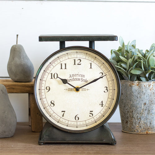 Black farmhouse scale clock styled with greenery and stone pears
