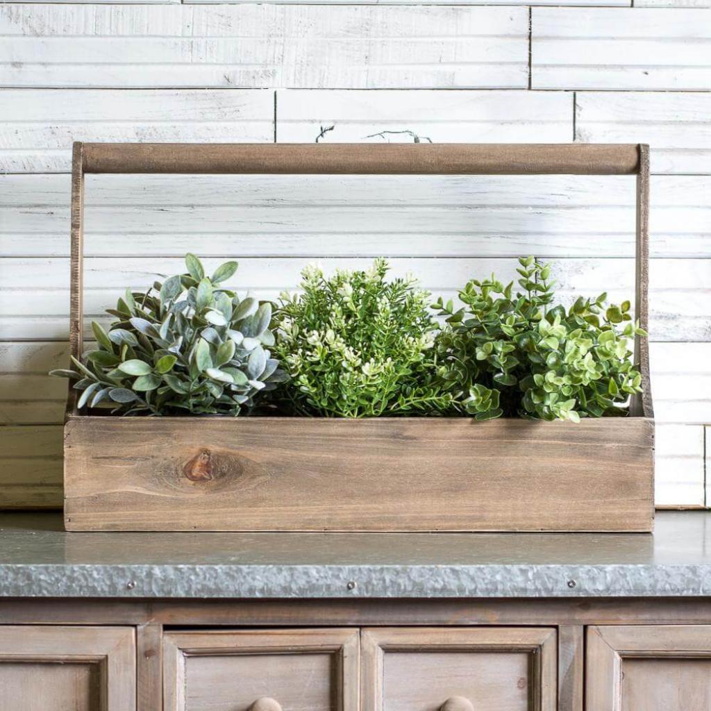 Wooden planter box with a tall handle and farmhouse greenery